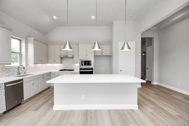 kitchen featuring oven, a center island, stainless steel dishwasher, pendant lighting, and built in microwave