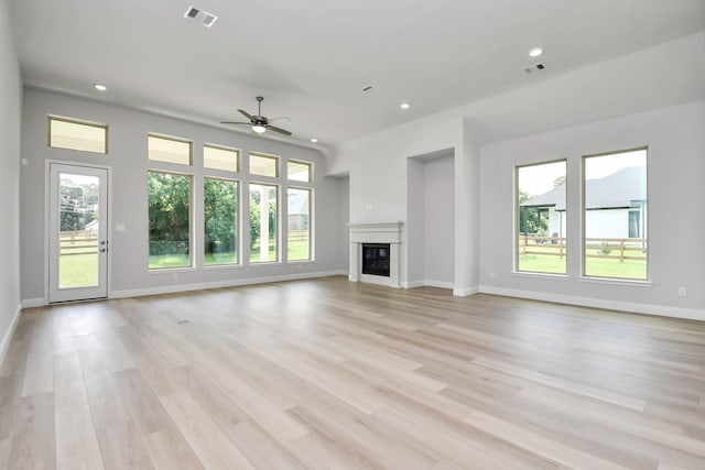 unfurnished living room with ceiling fan and light hardwood / wood-style flooring