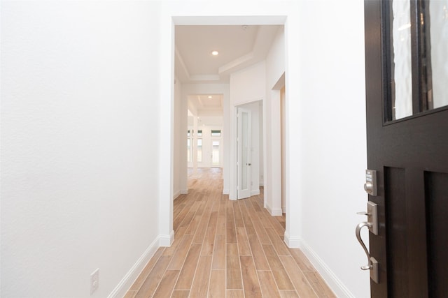 hallway featuring wood tiled floor and baseboards