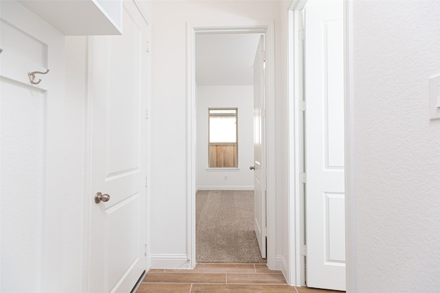 hall with wood tiled floor and baseboards