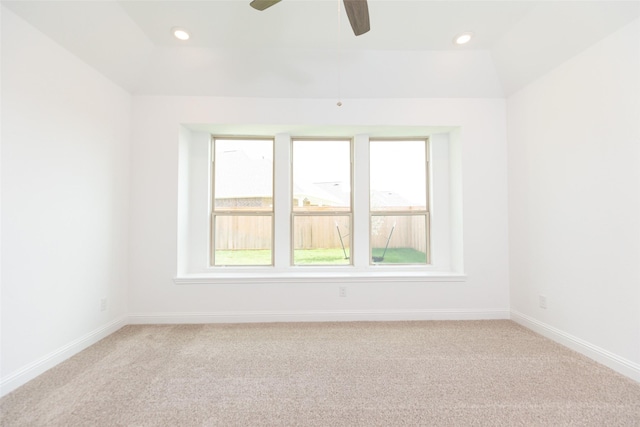 spare room with recessed lighting, lofted ceiling, a ceiling fan, light carpet, and baseboards