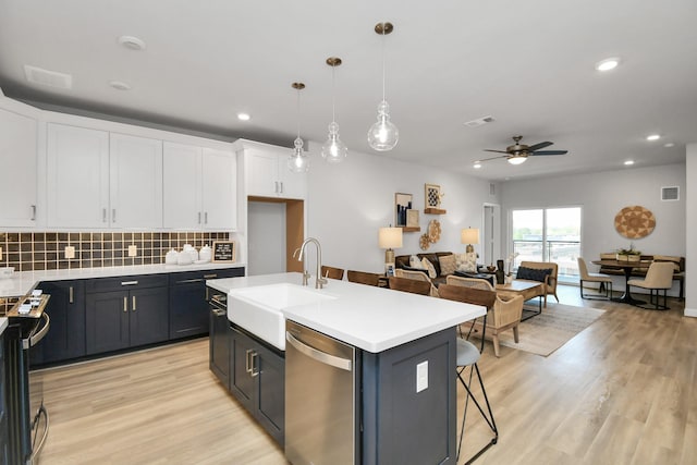 kitchen featuring sink, white cabinetry, ceiling fan, an island with sink, and stainless steel dishwasher