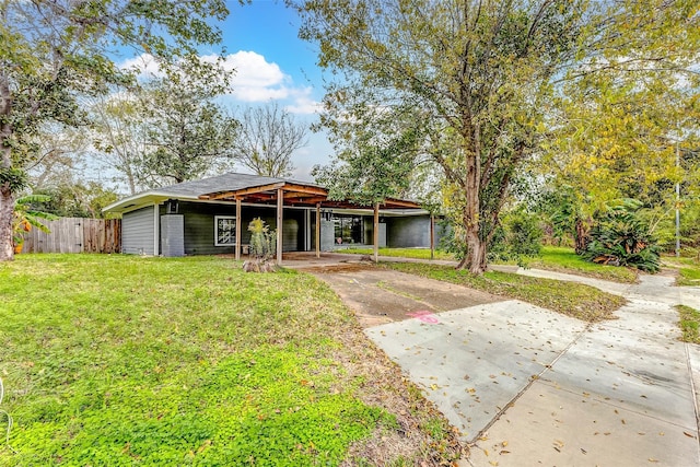 view of front of house with a front yard and a carport