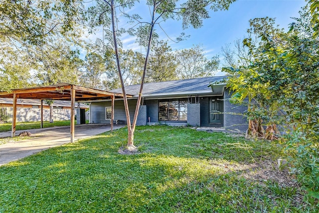 view of front facade with a front yard and a carport