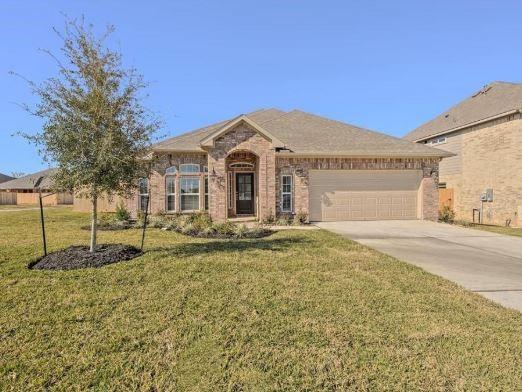 view of front of house with a garage and a front lawn