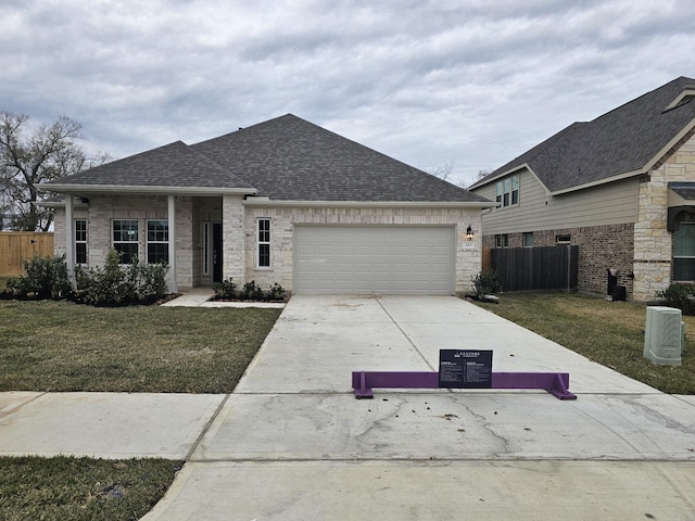 view of front of property with a front yard and a garage