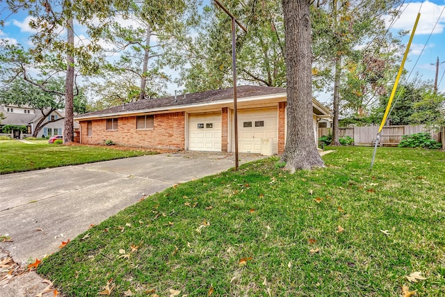 ranch-style home featuring a garage and a front lawn