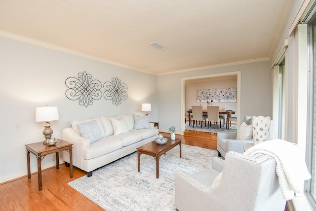 living room featuring crown molding and hardwood / wood-style flooring