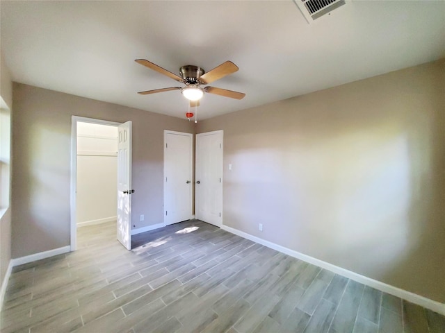 unfurnished bedroom featuring ceiling fan and light hardwood / wood-style floors