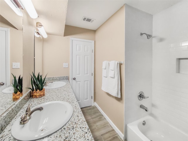 bathroom featuring vanity and washtub / shower combination