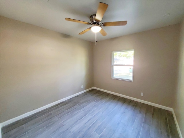 spare room with wood-type flooring and ceiling fan