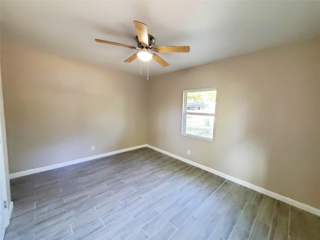 unfurnished room with ceiling fan and wood-type flooring