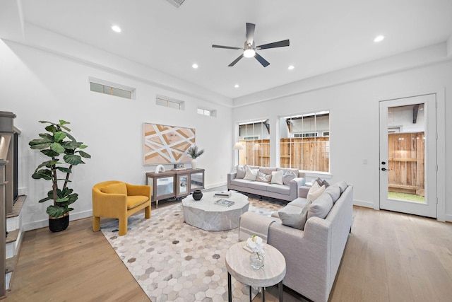 living room featuring light wood-type flooring and ceiling fan