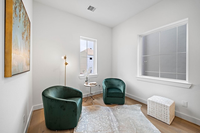 sitting room with wood-type flooring