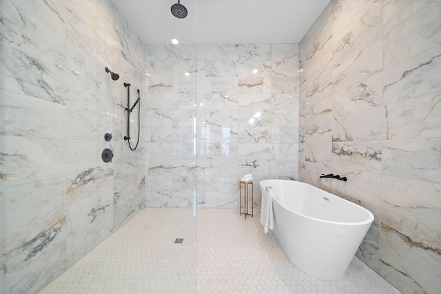 bathroom featuring shower with separate bathtub, tile walls, and tile patterned floors