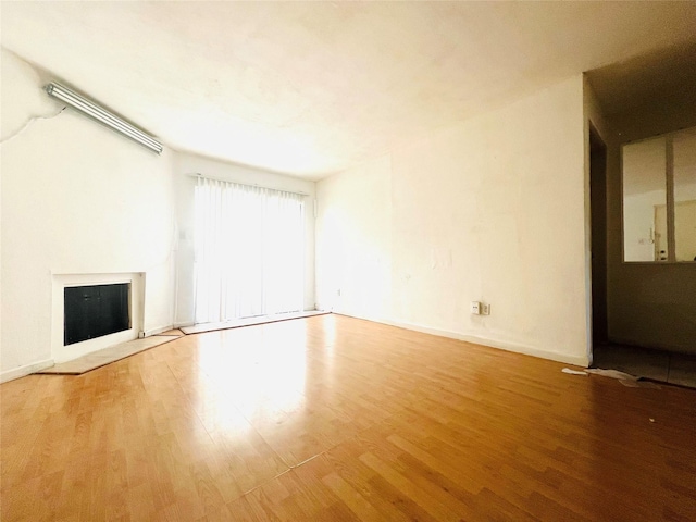 unfurnished living room featuring hardwood / wood-style floors