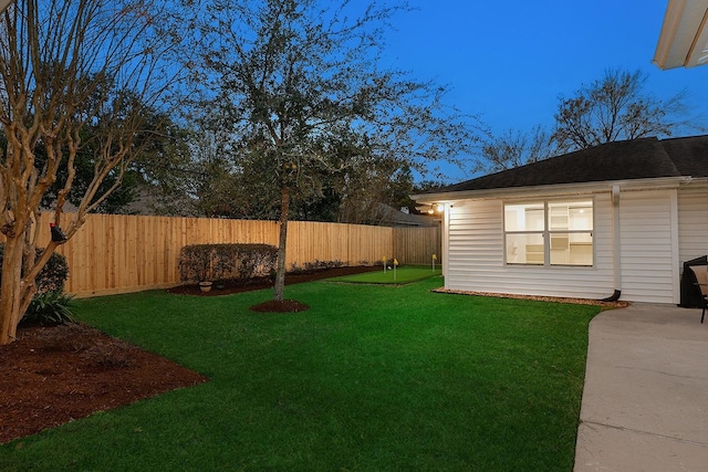 yard at dusk with a patio area