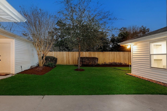 view of yard at dusk