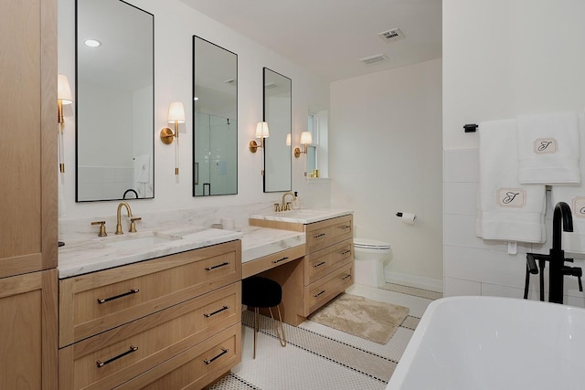 full bathroom featuring toilet, vanity, tile patterned floors, and independent shower and bath