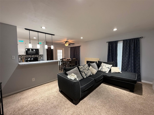 living room with ceiling fan and light colored carpet