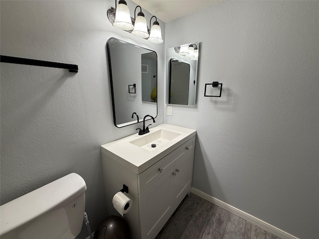 bathroom with toilet and vanity