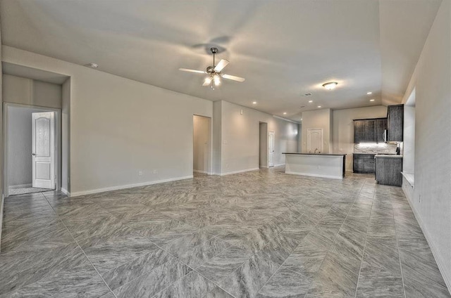 unfurnished living room featuring ceiling fan