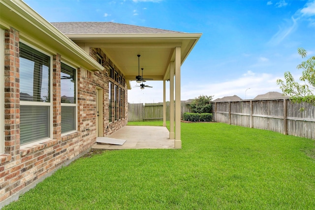 view of yard featuring ceiling fan and a patio