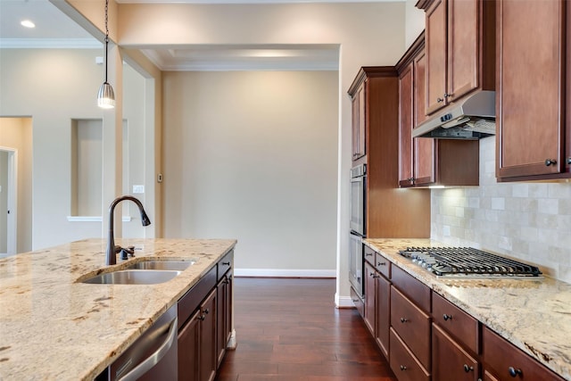 kitchen featuring stainless steel appliances, light stone counters, dark hardwood / wood-style floors, sink, and decorative light fixtures