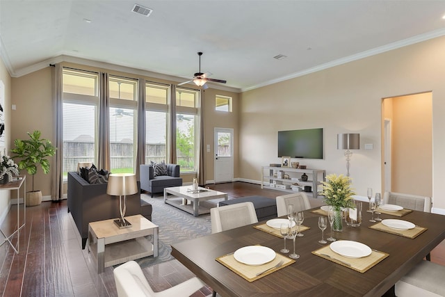 dining space with dark hardwood / wood-style flooring, ceiling fan, and ornamental molding