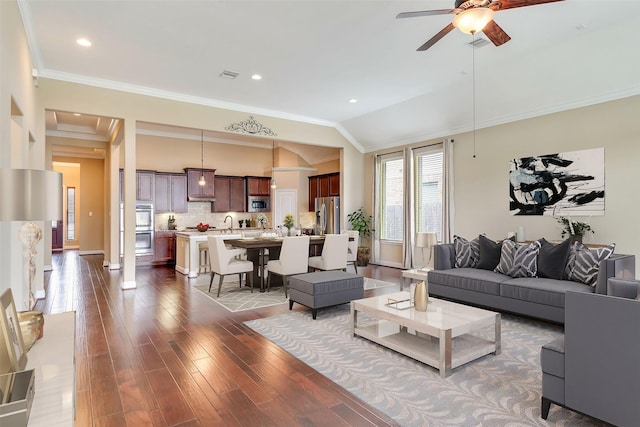 living room featuring ornamental molding, ceiling fan, lofted ceiling, and dark wood-type flooring