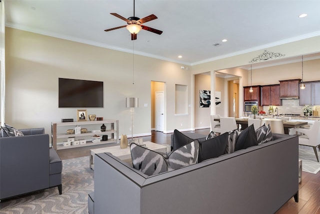 living room featuring ceiling fan, crown molding, and dark hardwood / wood-style flooring