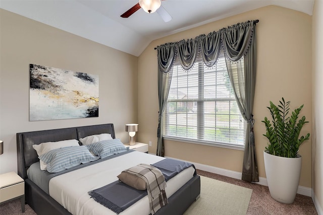 bedroom featuring lofted ceiling, multiple windows, ceiling fan, and carpet flooring