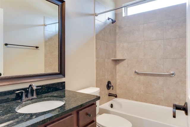 full bathroom with toilet, vanity, and tiled shower / bath