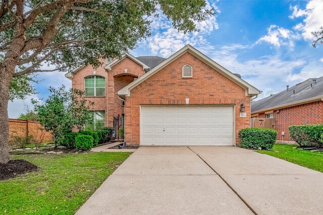 view of front property featuring a front lawn and a garage