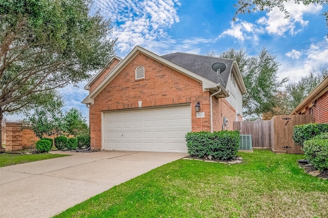 view of front of house featuring a garage, central AC, and a front yard