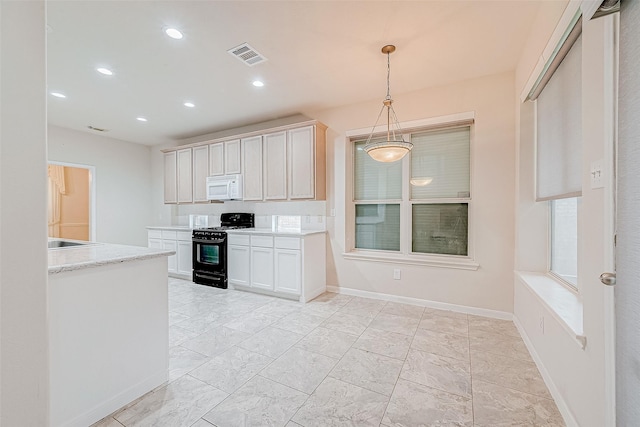 kitchen featuring white cabinetry, light stone countertops, black gas range oven, and decorative light fixtures