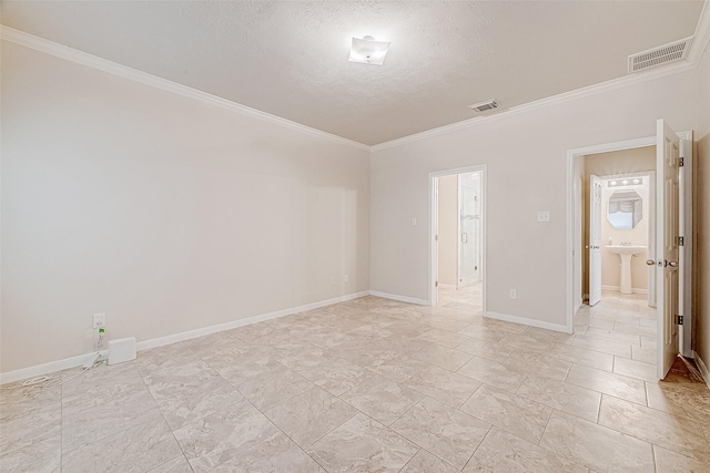 unfurnished room with crown molding and a textured ceiling