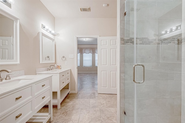 bathroom featuring vanity and a shower with shower door