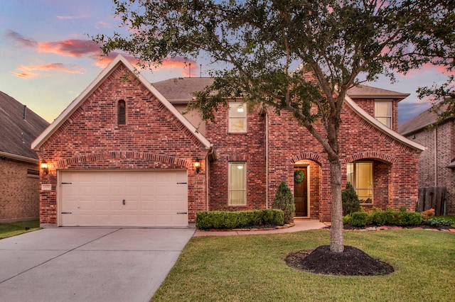 view of front of house with a yard and a garage