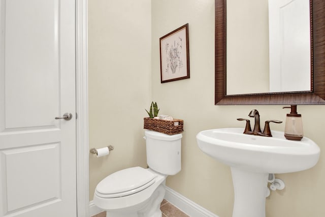 bathroom with toilet and tile patterned floors