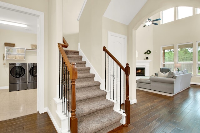 stairs with washing machine and dryer and ceiling fan