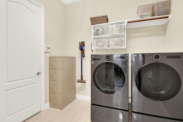 laundry room featuring light tile patterned floors and independent washer and dryer