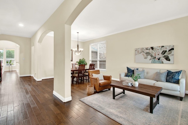 living room with dark wood-type flooring and a chandelier