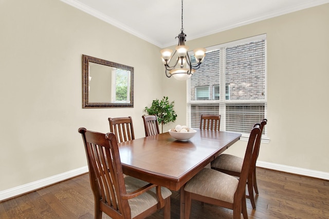 dining room with a notable chandelier, crown molding, and dark hardwood / wood-style floors