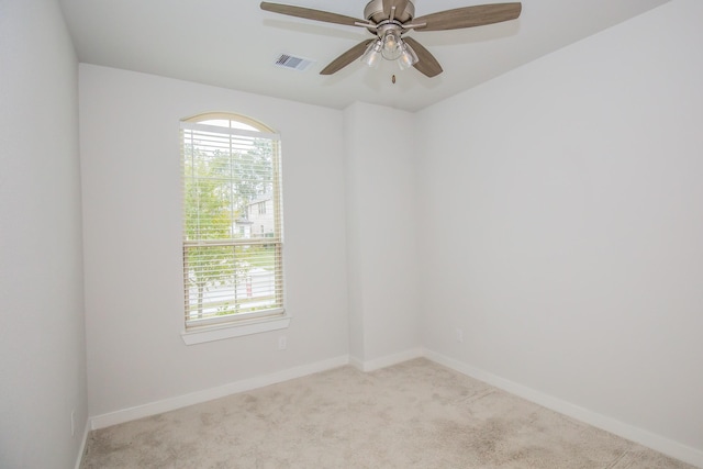 carpeted spare room with ceiling fan