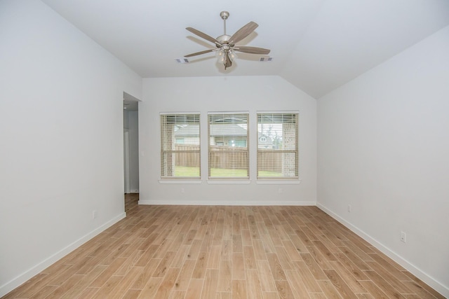 spare room with vaulted ceiling, ceiling fan, and light hardwood / wood-style floors