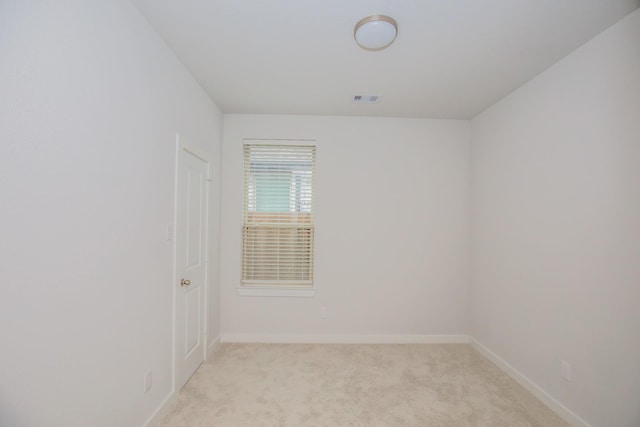 spare room with light colored carpet