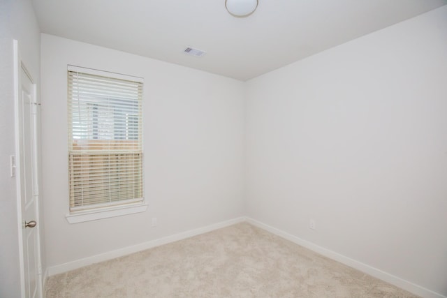 unfurnished room with light colored carpet