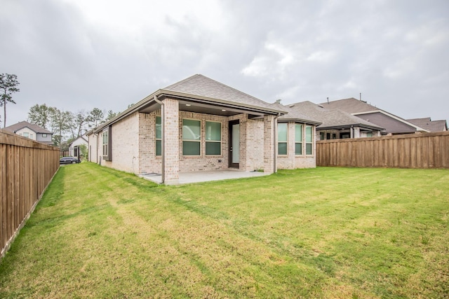 back of property featuring a patio area and a yard