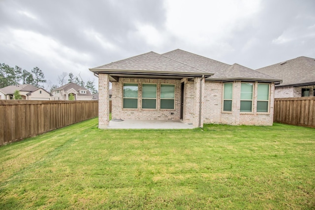 back of house featuring a yard and a patio